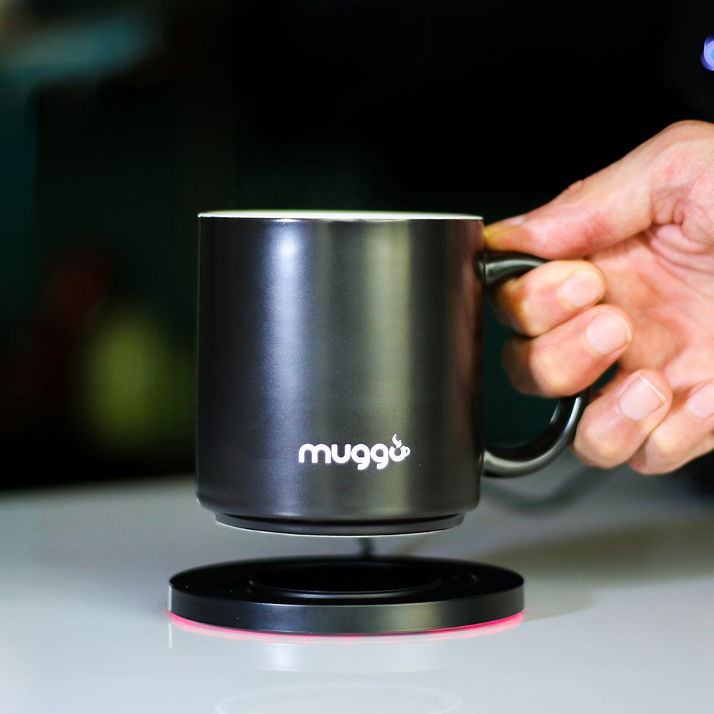 a person putting down Muggo cup