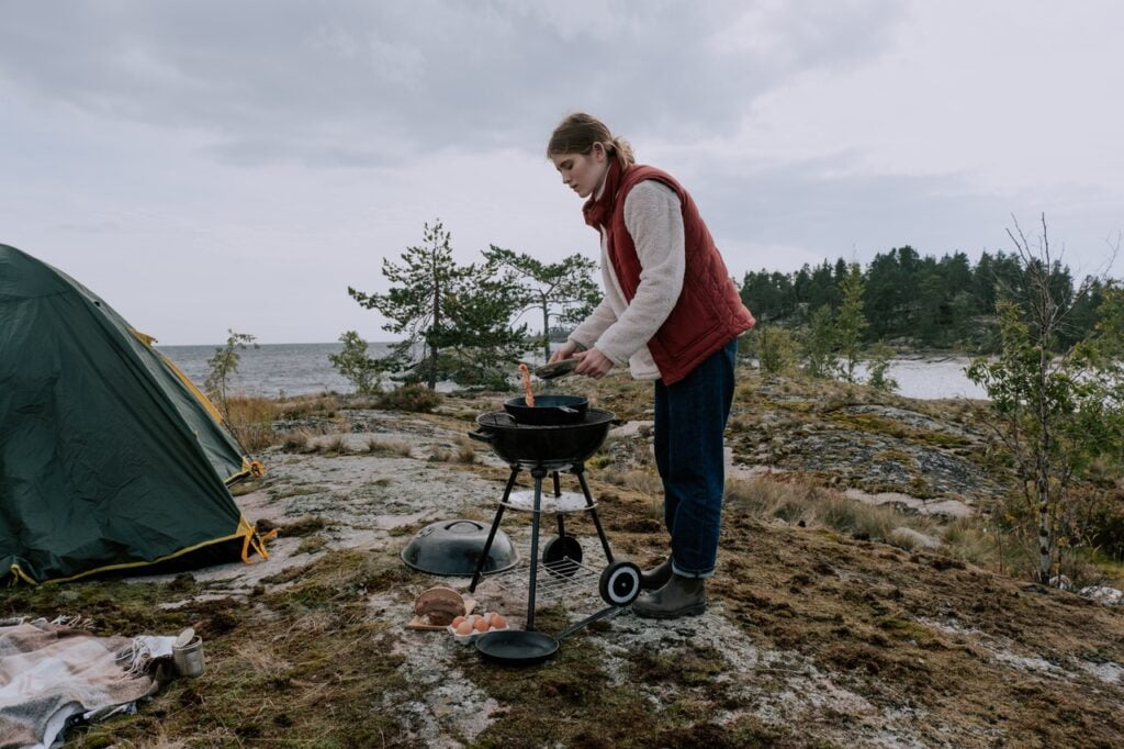 Woman cooking at campsite
